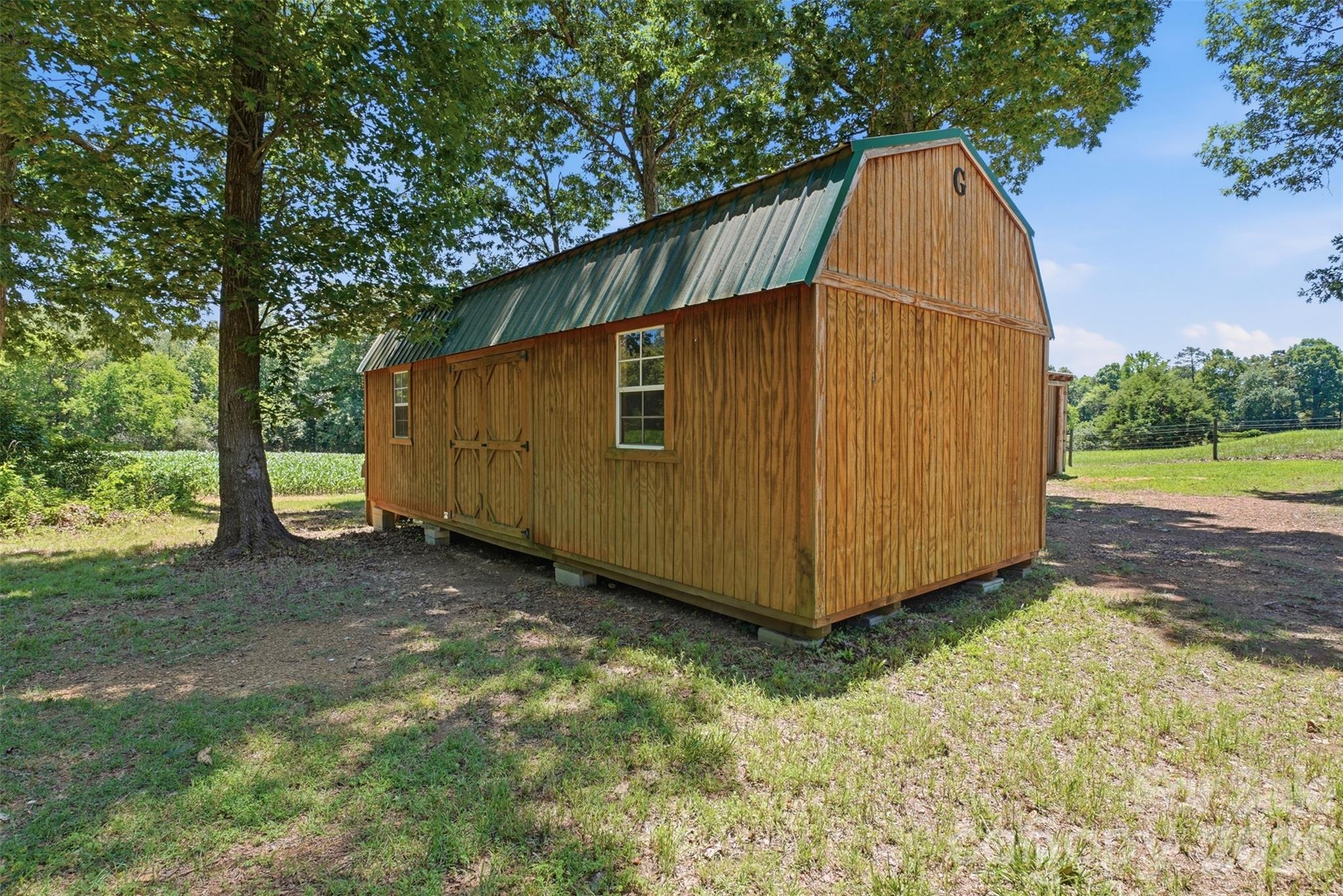 4406 Lucy Short Cut Road Marshville, NC 28103 - Photo 23 of 30 a view of backyard with large tree and wooden fence
