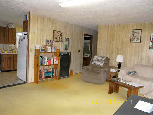 1785 Uhaloa Road Hilo, HI 96720 - Photo 4 of 12 a living room with furniture and a kitchen area