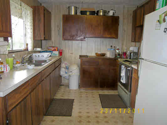 1785 Uhaloa Road Hilo, HI 96720 - Photo 5 of 12 a kitchen with a sink stove and refrigerator