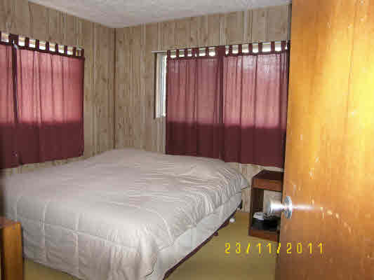 1785 Uhaloa Road Hilo, HI 96720 - Photo 9 of 12 a bed sitting in a bedroom next to a window and a balcony