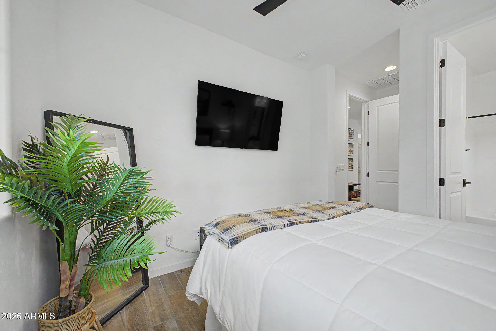 819 West Deer Creek Road Phoenix, AZ 85048 - Photo 41 of 76 a bedroom with a bed a mirror and a potted plant