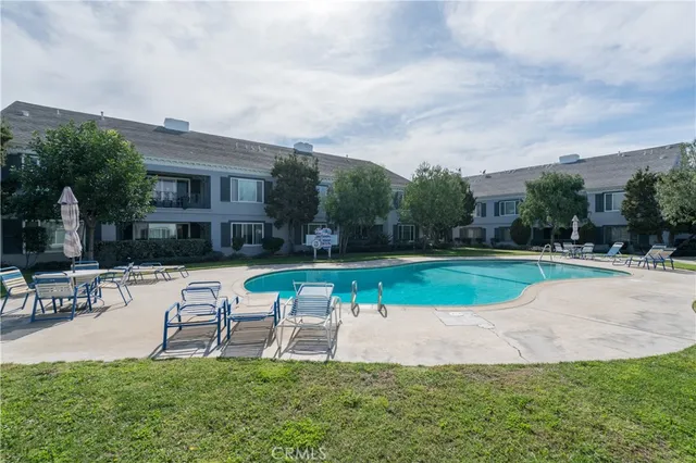 a view of backyard with seating area and green space