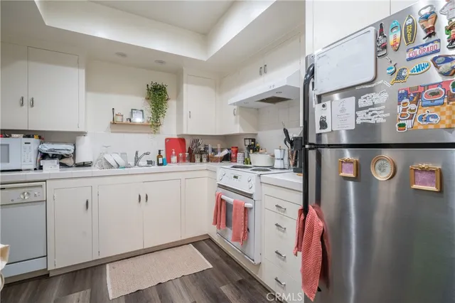a kitchen with stainless steel appliances cabinets and a window