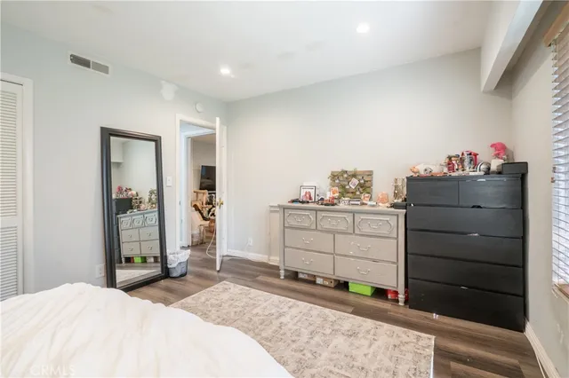 a bedroom with a bed and a dresser