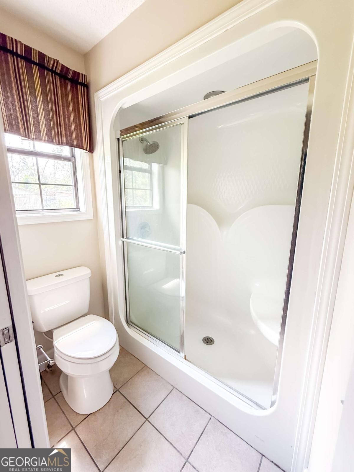 371 Burketts Ferry Road Hazlehurst, GA 31539 - Photo 30 of 53 a bathroom with a toilet and a shower
