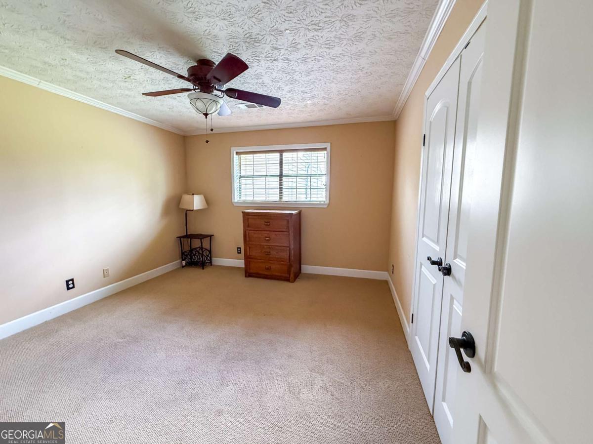371 Burketts Ferry Road Hazlehurst, GA 31539 - Photo 36 of 53 wooden floor in an empty room with a window