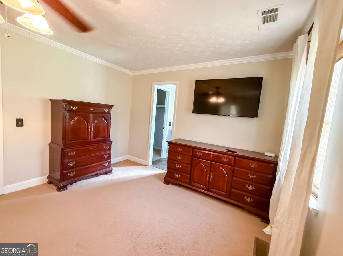 371 Burketts Ferry Road Hazlehurst, GA 31539 - Photo 41 of 53 a room with furniture and a flat screen tv