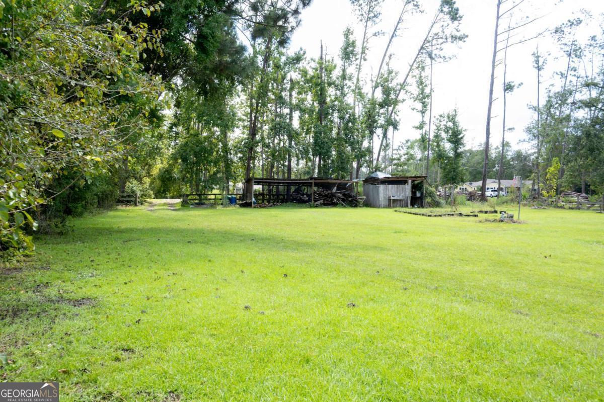 371 Burketts Ferry Road Hazlehurst, GA 31539 - Photo 50 of 53 a swimming pool with trees in the background