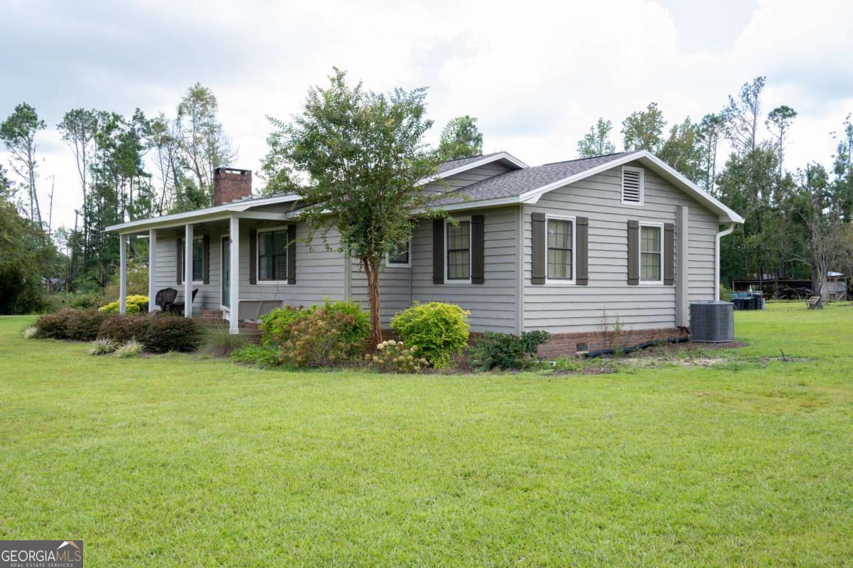 371 Burketts Ferry Road Hazlehurst, GA 31539 - Photo 5 of 53 a front view of a house with yard and green space