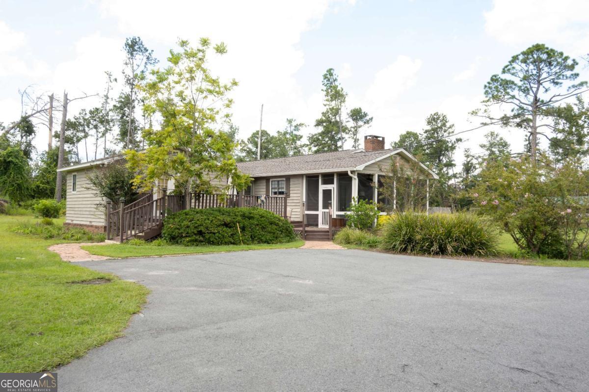 371 Burketts Ferry Road Hazlehurst, GA 31539 - Photo 6 of 53 a front view of a house with a yard and potted plants