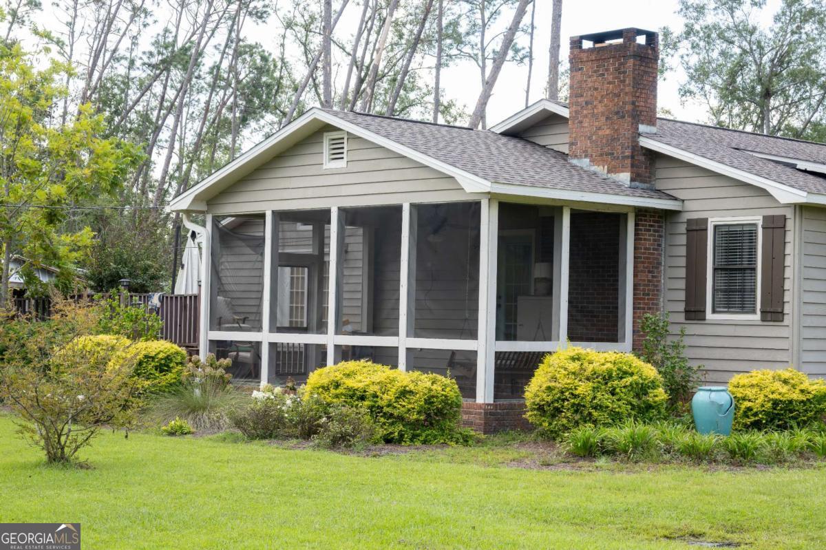 371 Burketts Ferry Road Hazlehurst, GA 31539 - Photo 7 of 53 a front view of a house with garden