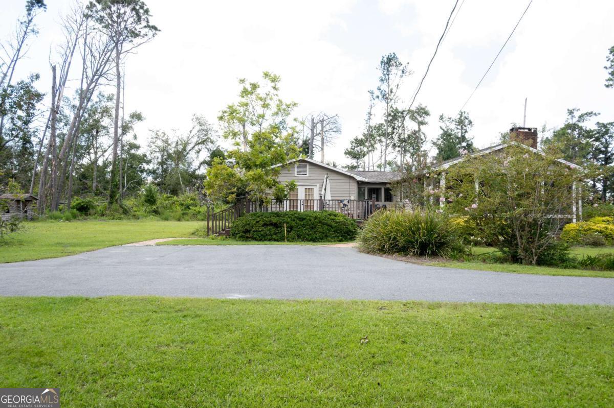 371 Burketts Ferry Road Hazlehurst, GA 31539 - Photo 10 of 53 a view of a house with a backyard