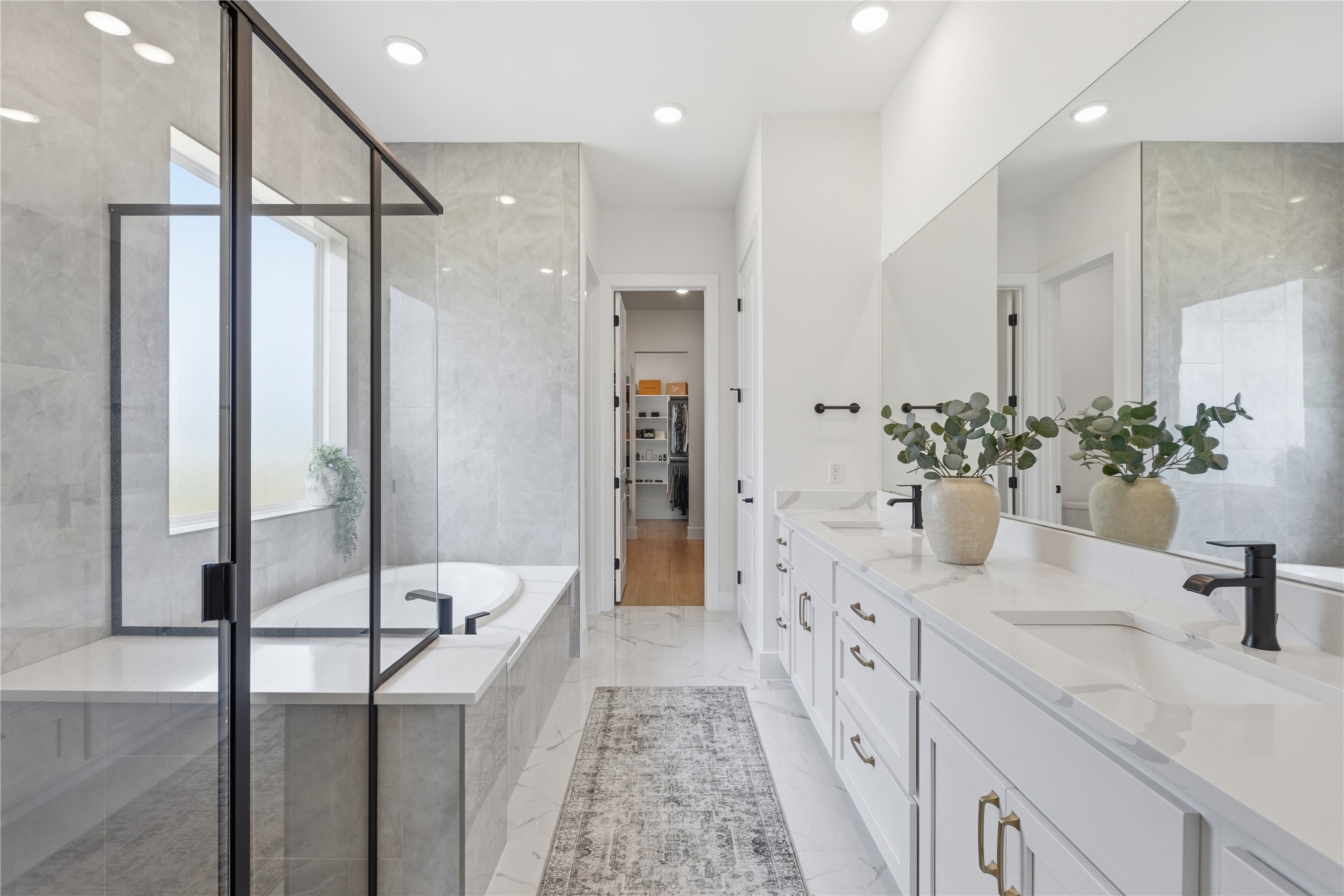 836 Villa Rialto View Leander, TX 78641 - Photo 16 of 33 Luxurious primary bath with double vanity, soaking tub, and walk-in closet access.