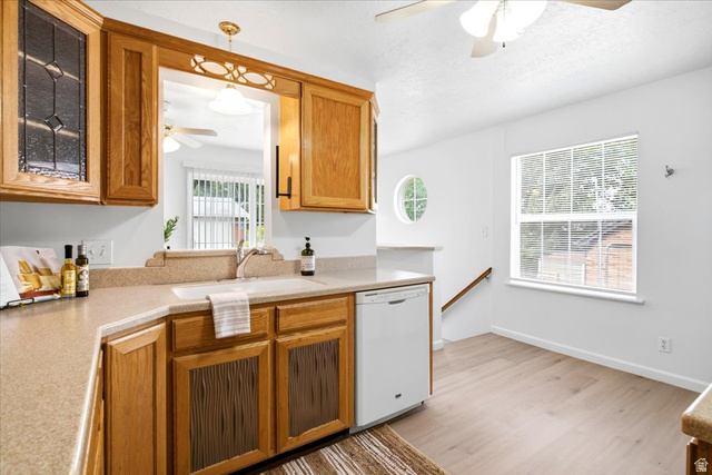 1341 29th Street Ogden, UT 84403 - Photo 12 of 37 Kitchen featuring wood cabinetry, a pass-through window, and a built-in dishwasher
