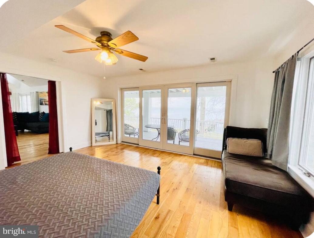 820 Bay Front Avenue North Beach, MD 20714 - Photo 11 of 19 a living room with a bed furniture and a large window