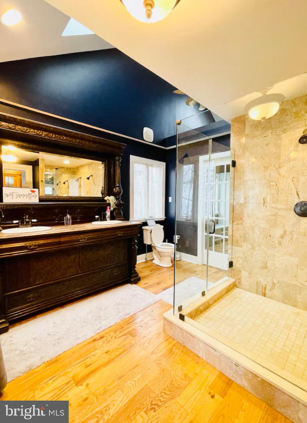 820 Bay Front Avenue North Beach, MD 20714 - Photo 12 of 19 a bathroom with a sink and a large mirror