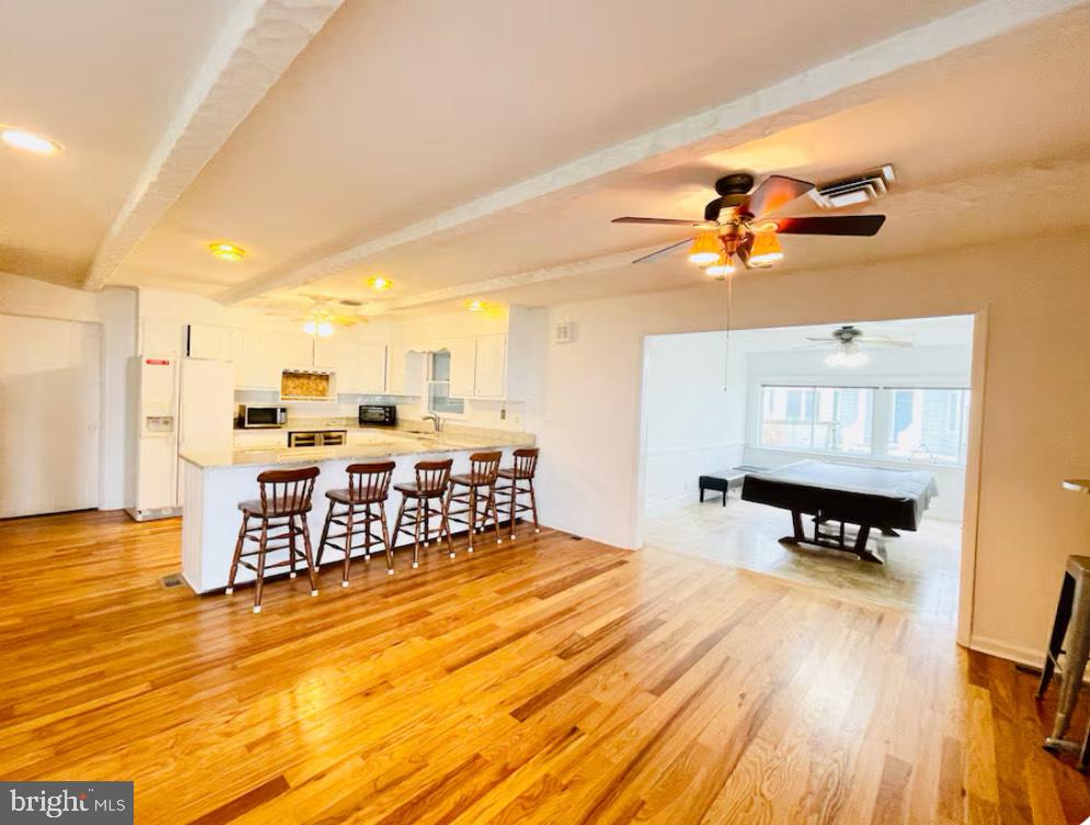 820 Bay Front Avenue North Beach, MD 20714 - Photo 15 of 19 a bedroom with a bed and wooden floor