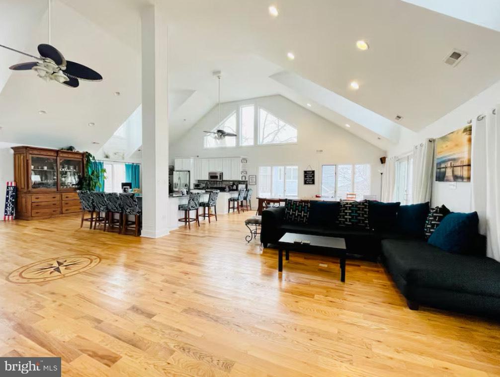 820 Bay Front Avenue North Beach, MD 20714 - Photo 4 of 19 a living room with couches and kitchen view with wooden floor