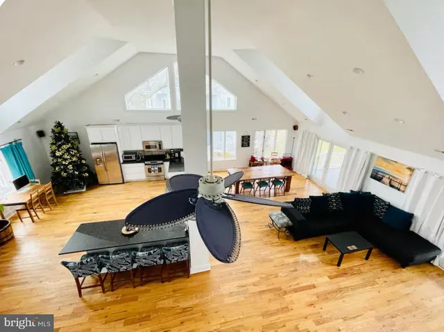 a living room with furniture and kitchen view