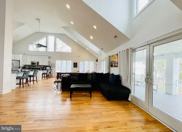 a living room with furniture and kitchen view