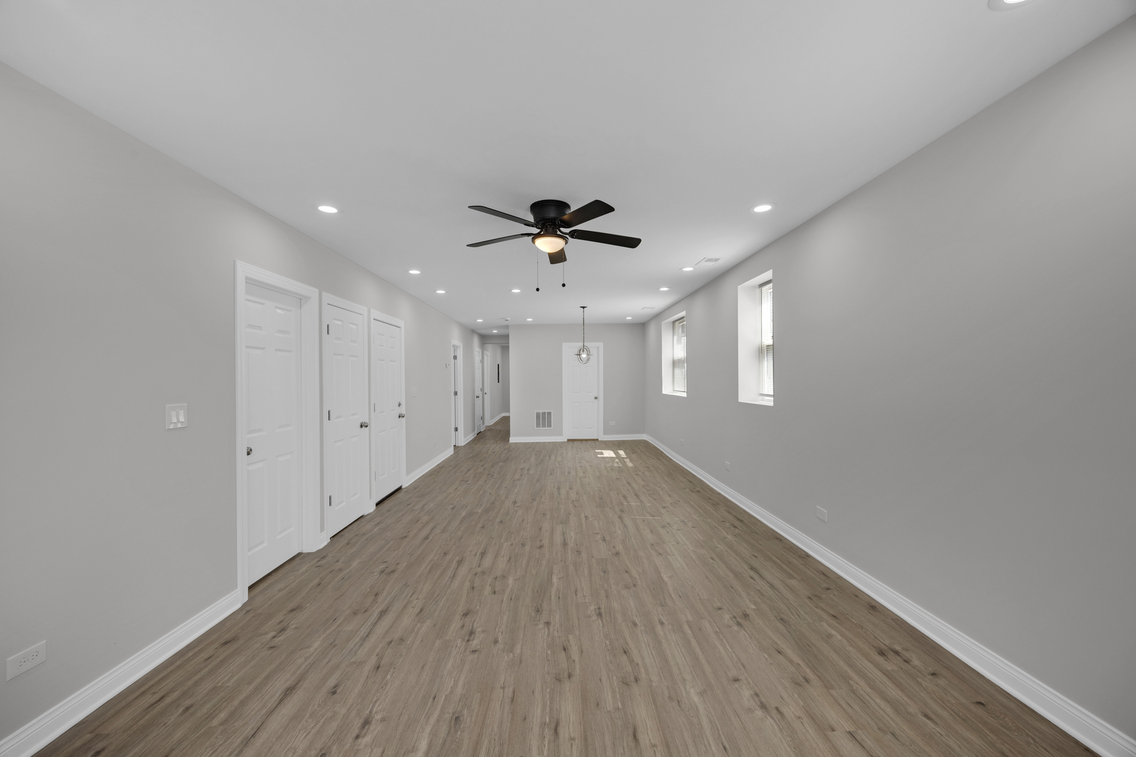 6807 South Paulina Street, Unit 1 Chicago, IL 60636 - Photo 2 of 5 a view of empty room with wooden floor and ceiling fan