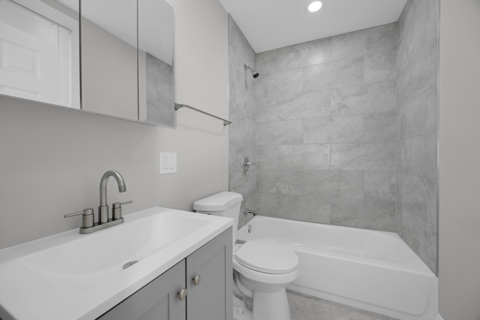 6807 South Paulina Street, Unit 1 Chicago, IL 60636 - Photo 4 of 5 a bathroom with a sink a toilet and bathtub