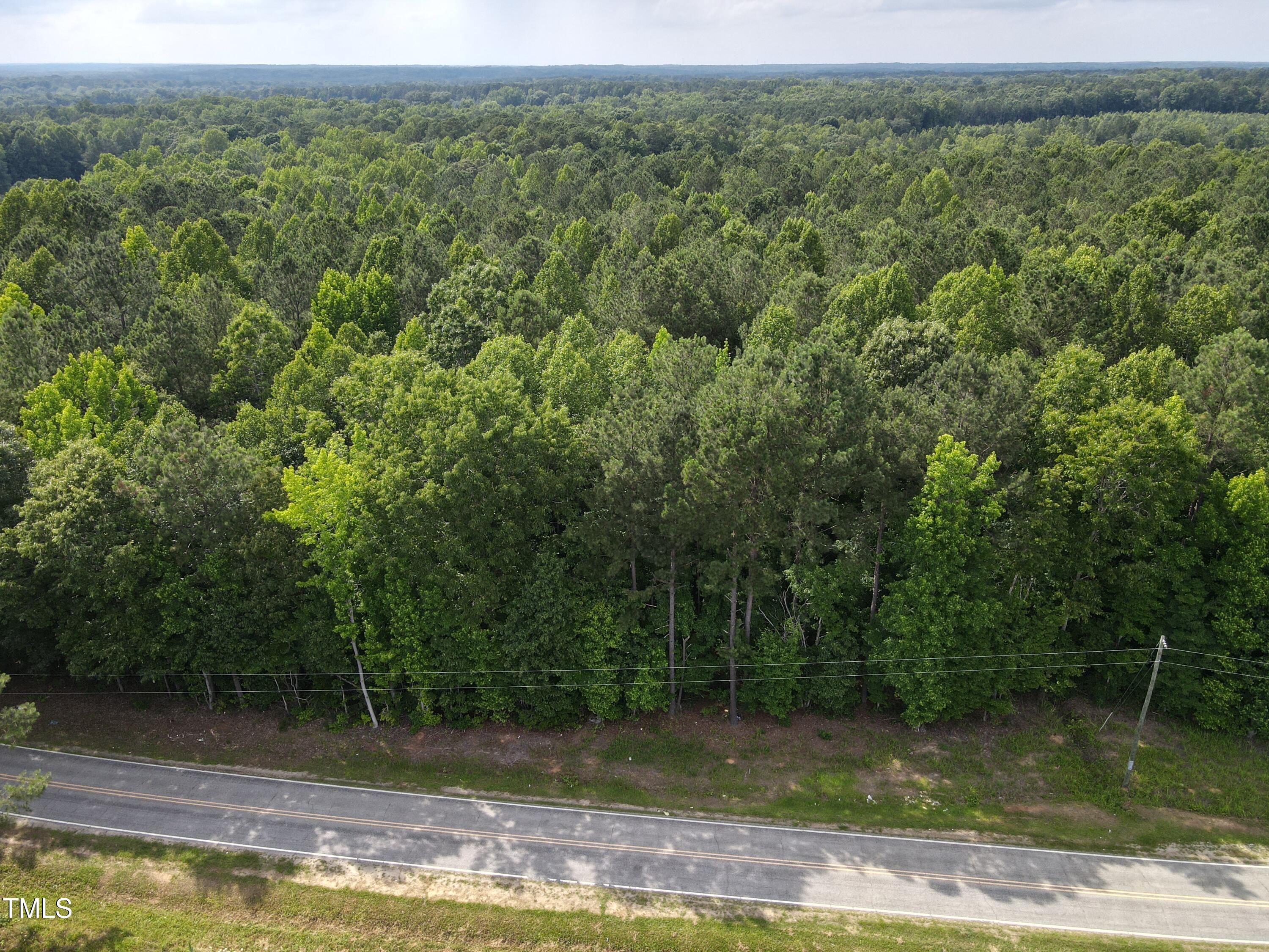 5-10 South Big Woods Road Spring Hope, NC 27882 - Photo 1 of 9 a view of a water pond with green landscape