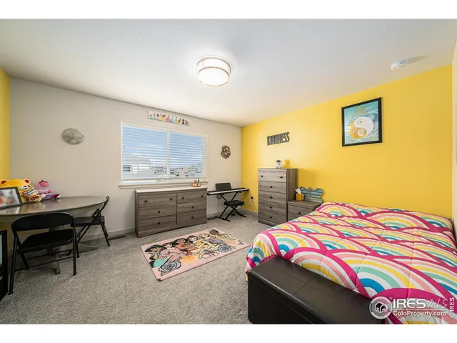 a bedroom that has a bed and a table in it