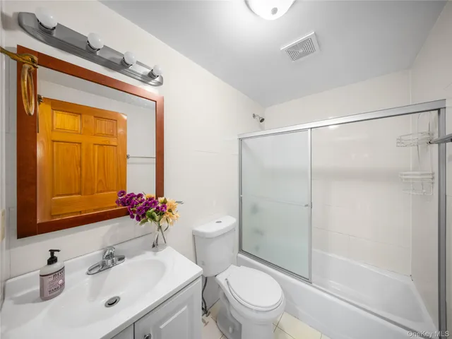 a bathroom with a sink mirror vanity and toilet