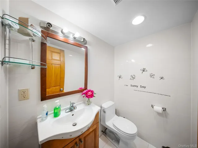 a bathroom with a sink mirror toilet and shower