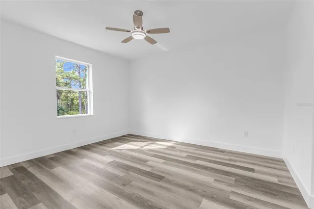 a view of empty room with ceiling fan