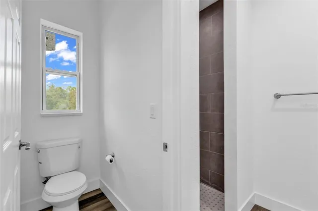 a white toilet sitting next to a bathroom sink
