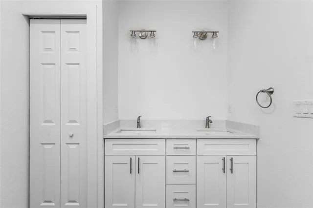 a bathroom with a sink and vanity