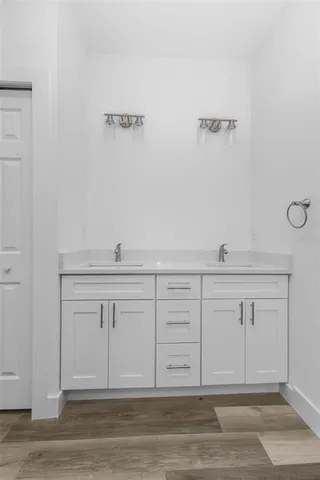 a view of a kitchen with white cabinets