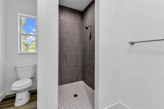 a bathroom with a toilet and a shower