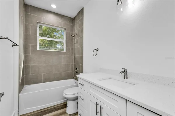 a bathroom with a sink a toilet and bathtub