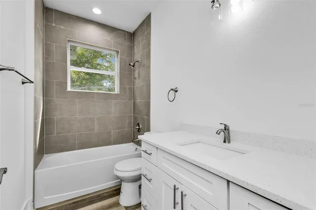 a bathroom with a sink a toilet and bathtub