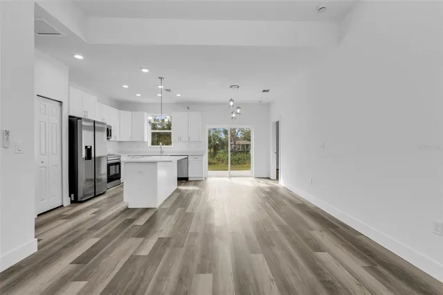 a view of kitchen with wooden floor and window