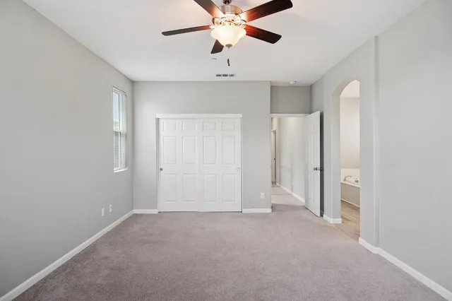 a bathroom with a tub a sink and mirror