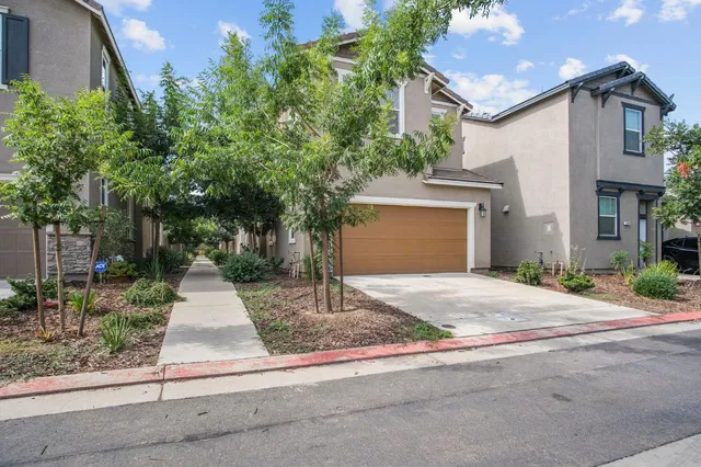 a front view of a house with yard