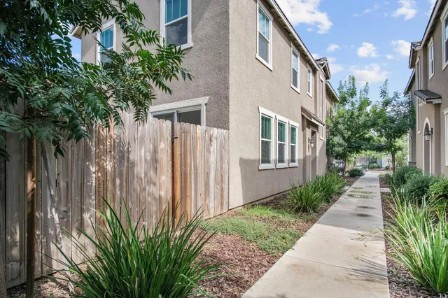 a backyard of a house with plants and trees