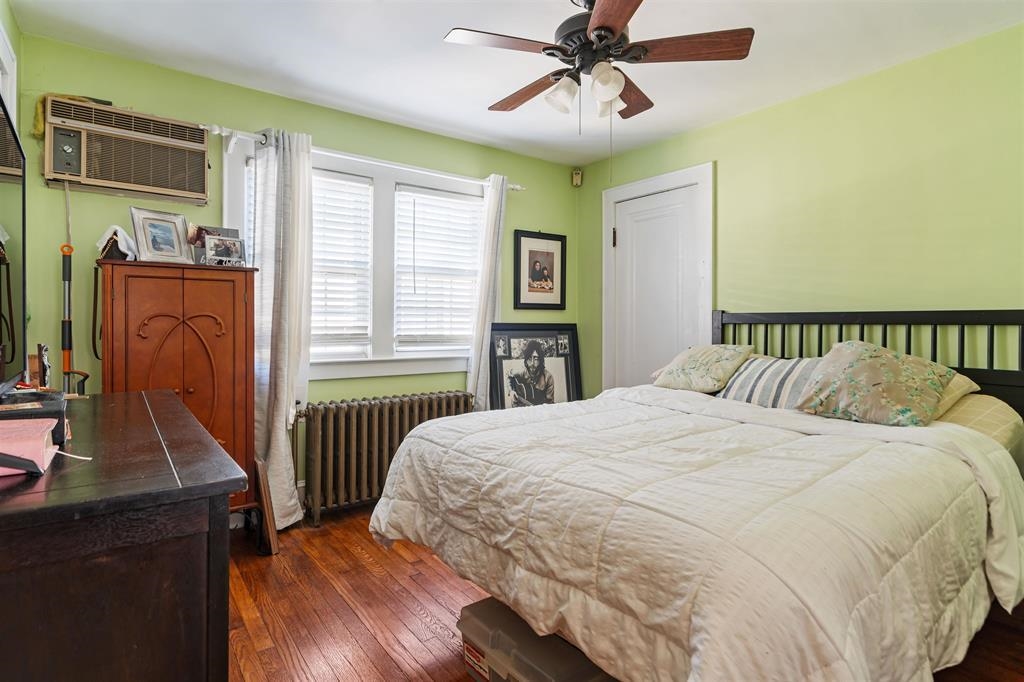 1041 Stonewall Lane, Unit 2 Secaucus, NJ 07094 - Photo 6 of 8 a bedroom with a bed next to a window with a flat screen tv
