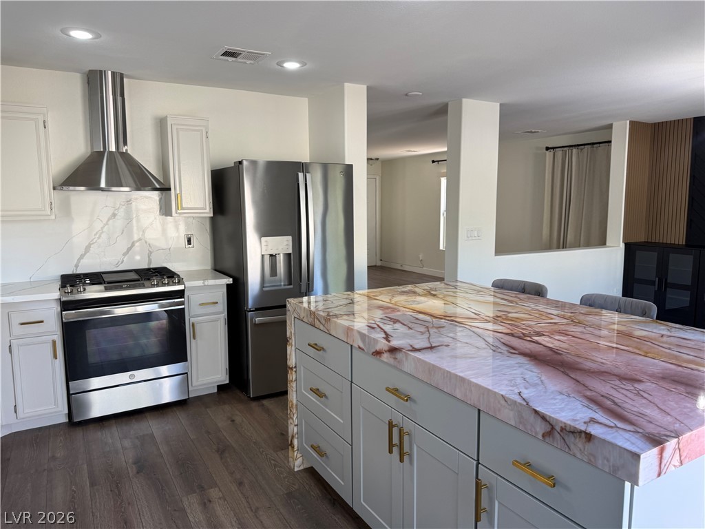 1141 Cathedral Ridge Street Henderson, NV 89052 - Photo 18 of 77 This modern kitchen features a spacious island, perfect for culinary adventures and social gatherings.