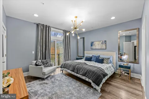a bedroom with a bed furniture and a large window