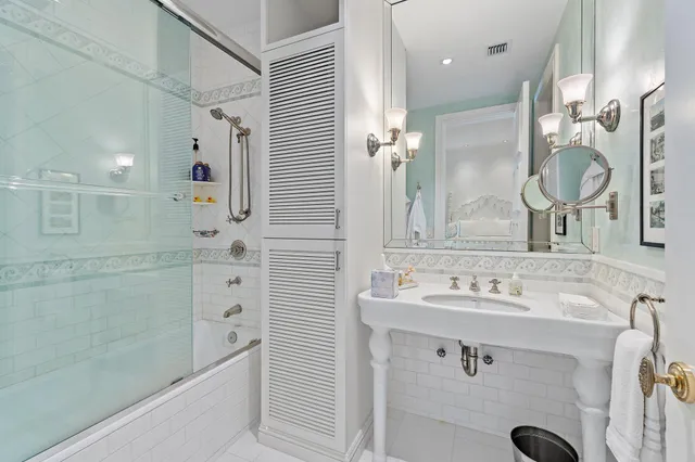 a bathroom with a sink double vanity and a shower
