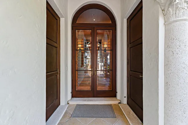 a front view of a house with garden and swimming pool
