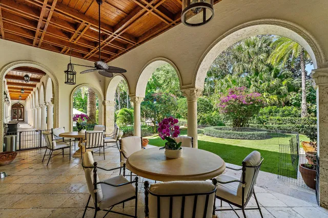 a living room with furniture a large window and gym equipment