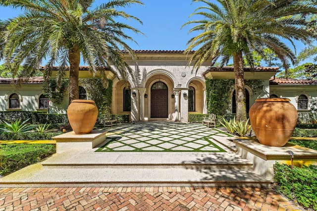 a kitchen with stainless steel appliances kitchen island granite countertop a table chairs and a chandelier