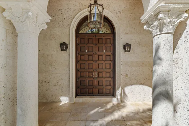 a kitchen with stainless steel appliances granite countertop a stove a sink dishwasher and white cabinets with wooden floor