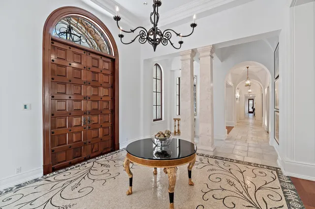 a living room with patio furniture and a large window